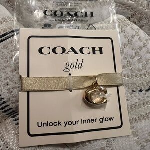 Coach Gold Fragrance Ribbon Bracelet with Gold Tone Coach C, new in package